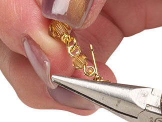 Jump ring is closed, completing the earring.